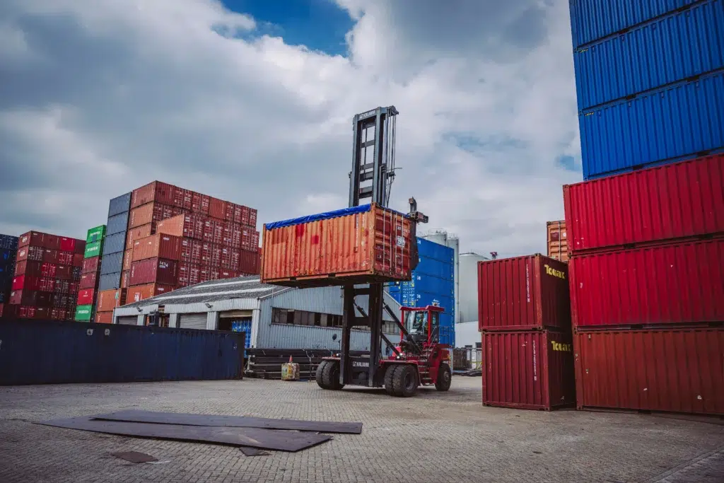 RCC container terminal in Rotterdam-Botlek with stacked sea containers and a reachstacker